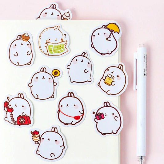 Set of cute cartoon character stickers on a pink background with a pen.