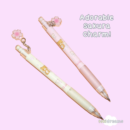 Pair of mechanical pencils with flower charm and Rilakkuma bear design on pastel purple background