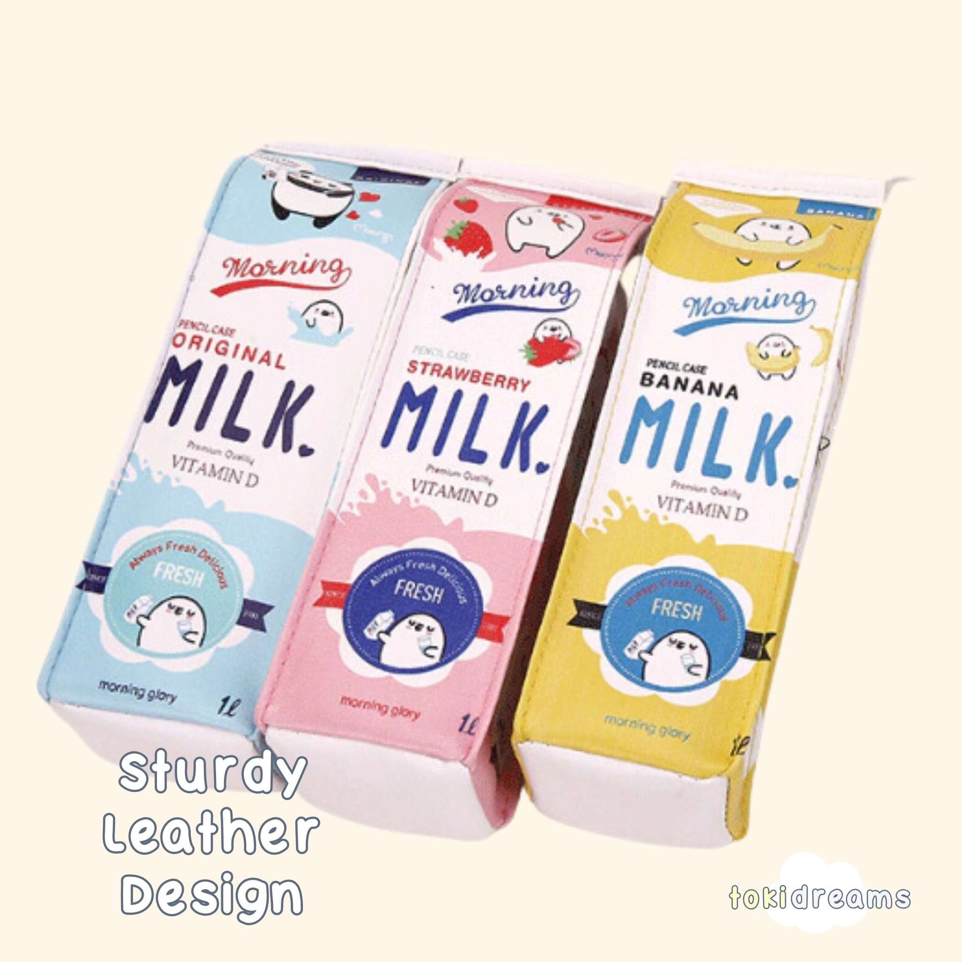 Three pencil pouches with cartoon animal designs, resembling a milk carton, in strawberry, banana, and blue colors.