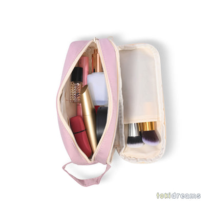 Pink cosmetic bag with makeup items on a white background
