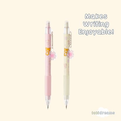 A pair of mechanical pencils with Sakura (cherry blossom) designs and Rilakkuma bear face in pink and white colors.