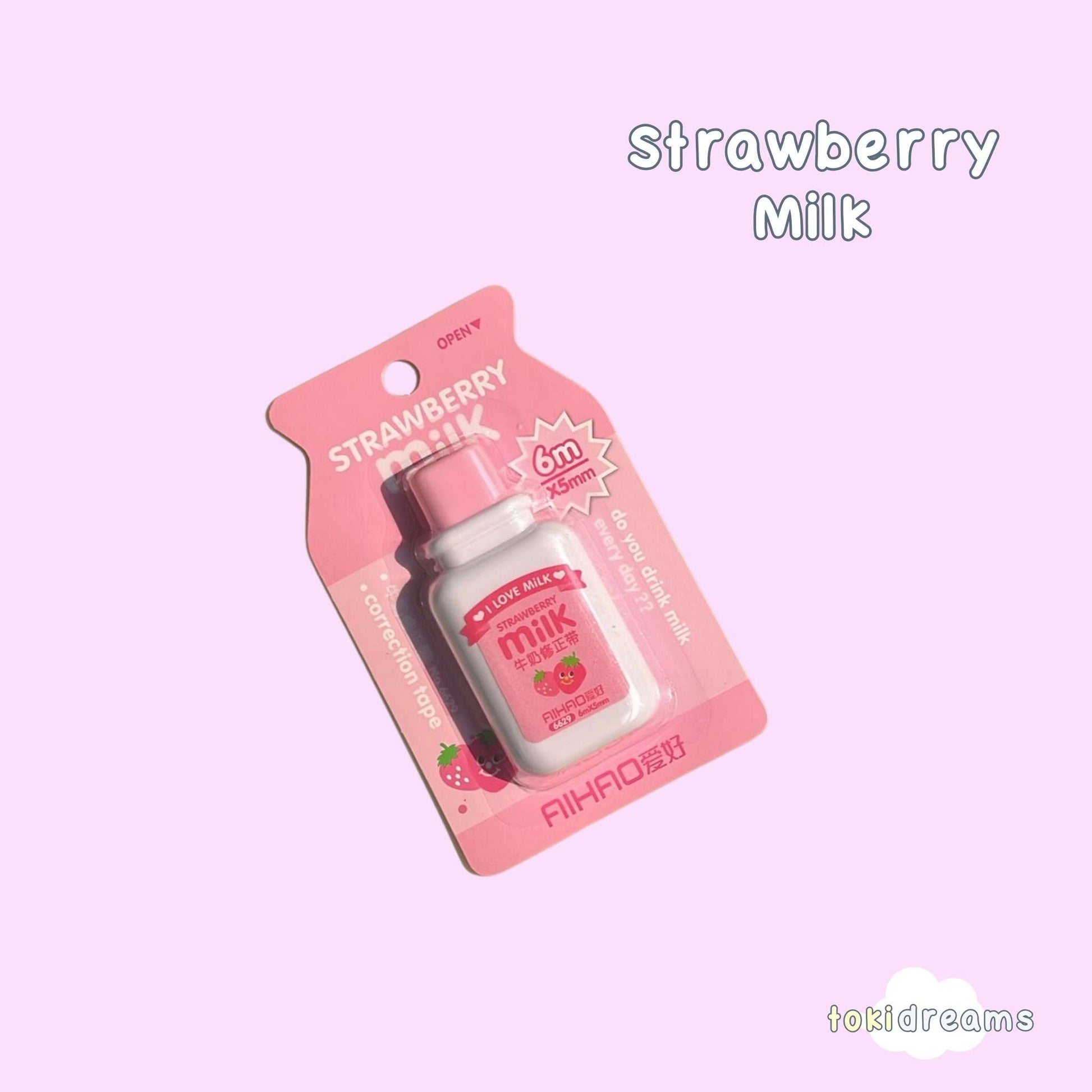 Correction tape in pink strawberry milk bottle packaging with product visible through clear window